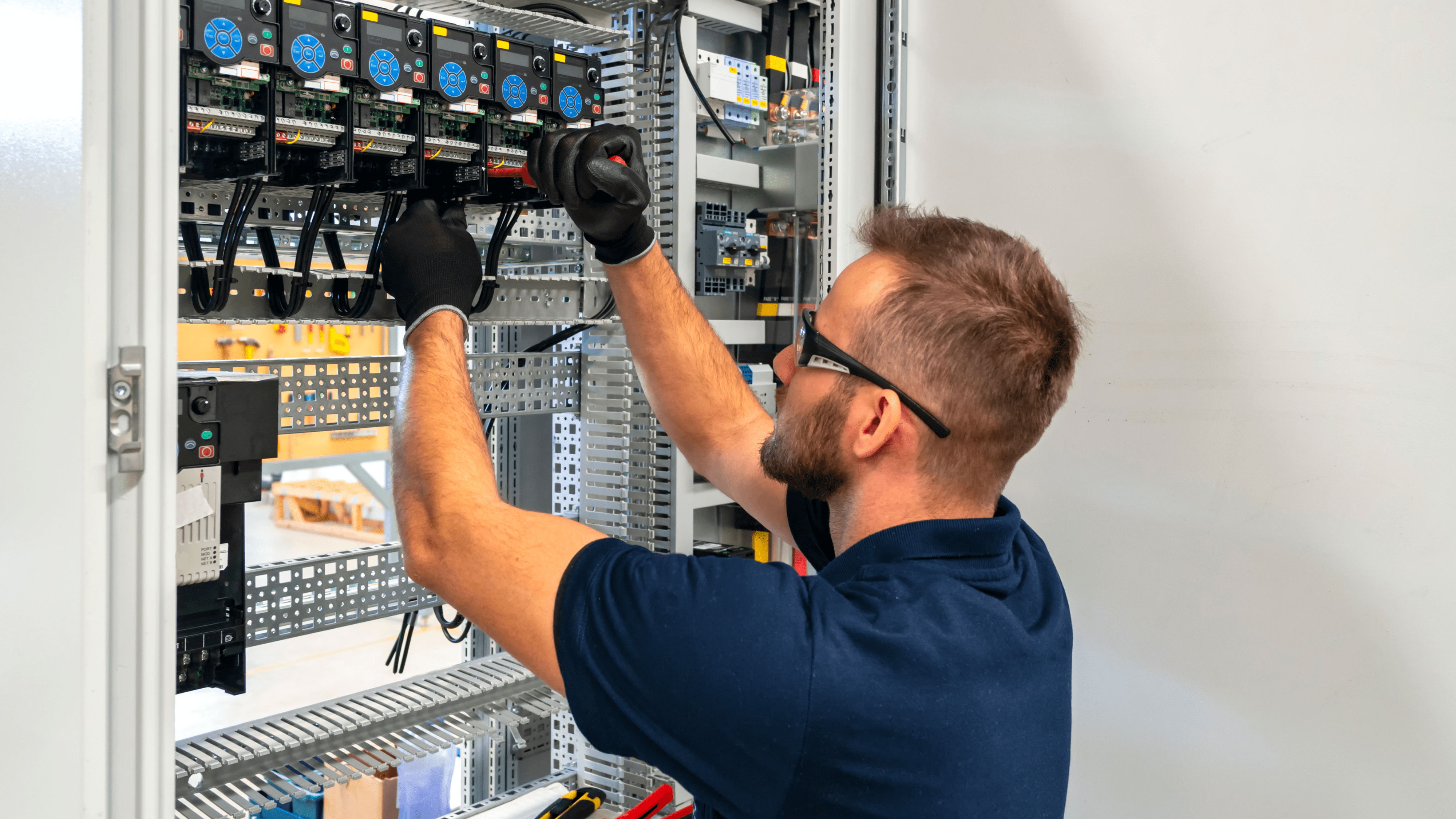 An engineer wearing safety glasses and gloves as he uses EPLAN's Smart Wiring virtual assistant to make the task easier and faster.